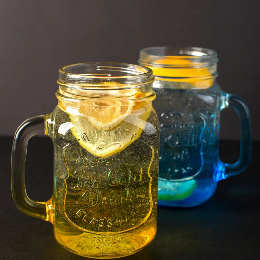 two cup of glasses with lemon slices in it