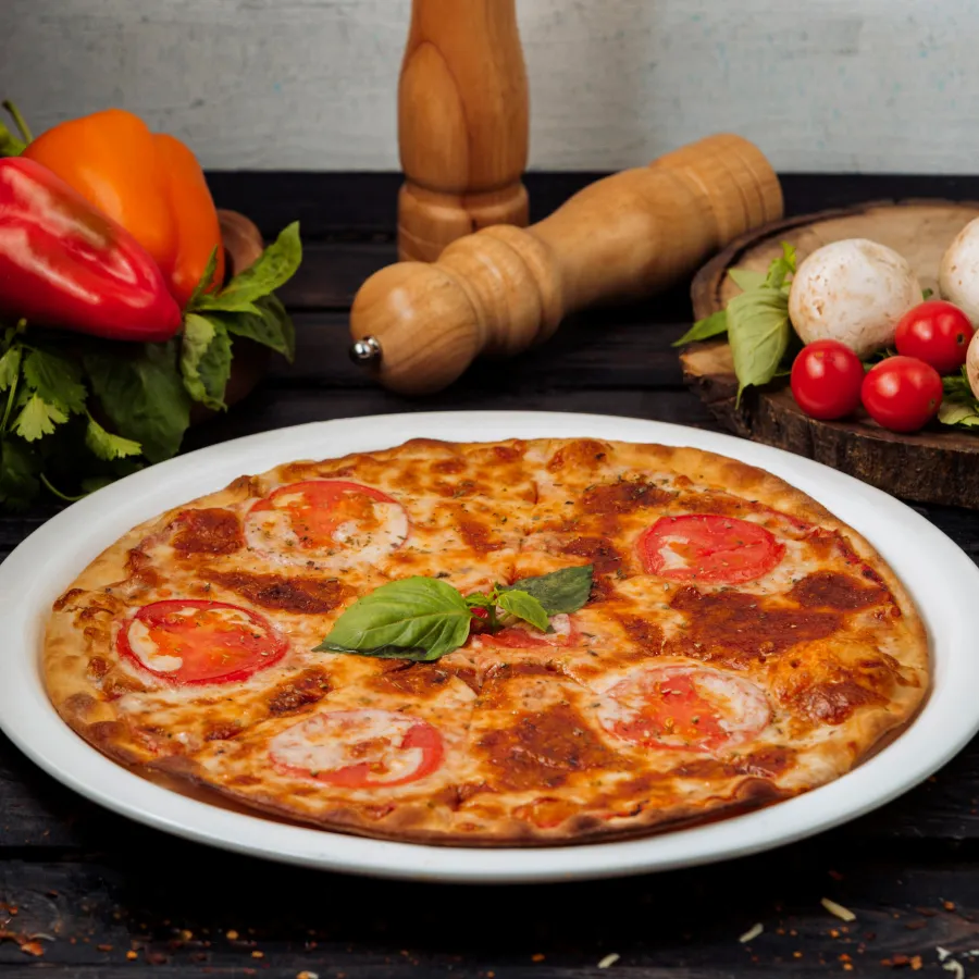 a pizza topped with some pepperoni on the top and served in a white dish